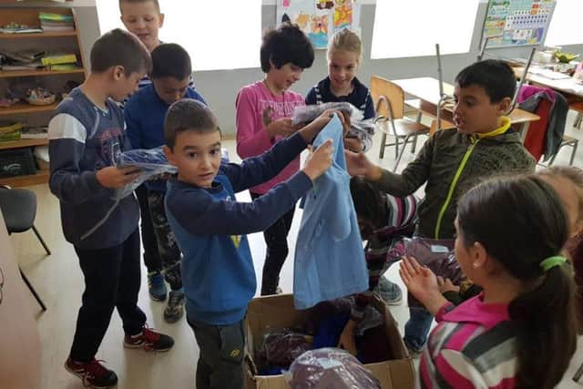 Children from 7 Noiembrie School in Romania receiving their donated items