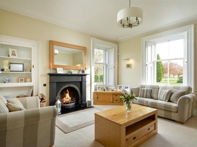 The formal lounge has an attractive feature fireplace