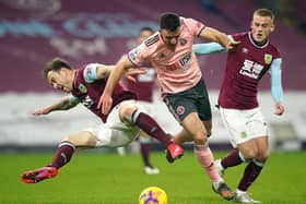 BURNLEY, ENGLAND - DECEMBER 29: Ashley Barnes of Burnley is challenged by Enda Stevens of Sheffield United during the Premier League match between Burnley and Sheffield United at Turf Moor. (Photo by Dave Thompson -