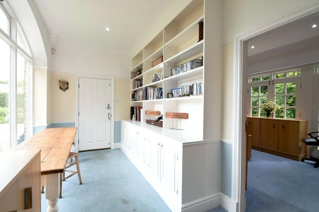 An inner hallway leads to a fully functional office and library area, which is ideal for working from home.