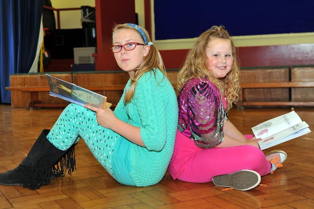 Golden Flatts primary school pupils Ellie Bate and Lani Young reading as they take part in Non Uniform Day seven years ago.