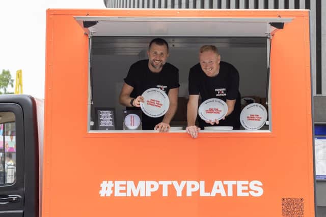 Ian Theasby and Vince Kelly pose with #EmptyPlates outside Kings Cross Station.