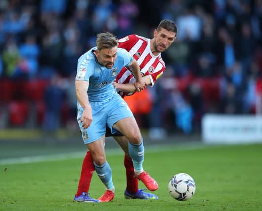 Matthew Godden of Coventry City tackled by Chris Basham of Sheffield United: Simon Bellis / Sportimage