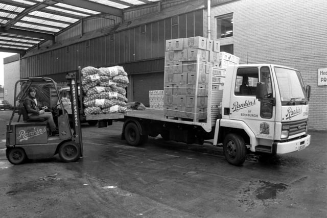 A Rankins forklift loads onions on to their lorry at Gorgie fruit market in Chesser Avenue Edinburgh, August 1983.