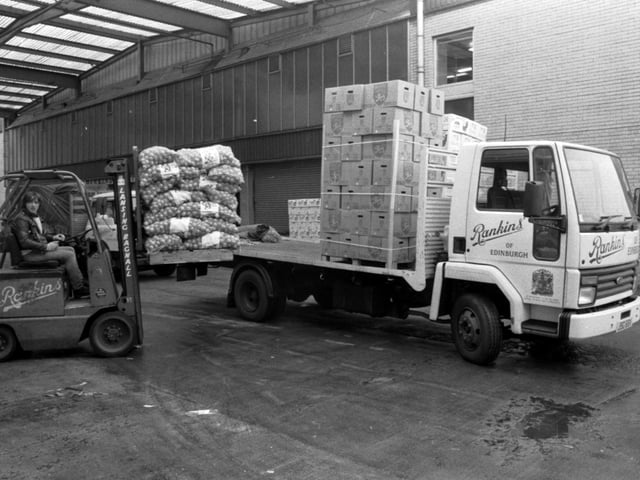 A Rankins forklift loads onions on to their lorry at Gorgie fruit market in Chesser Avenue Edinburgh, August 1983.