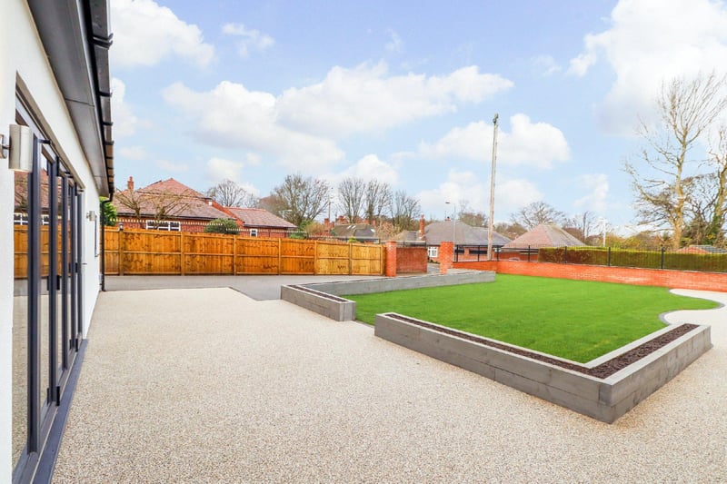 The main garden is laid to lawn with feature raised beds created out of contemporary-style railway sleepers.