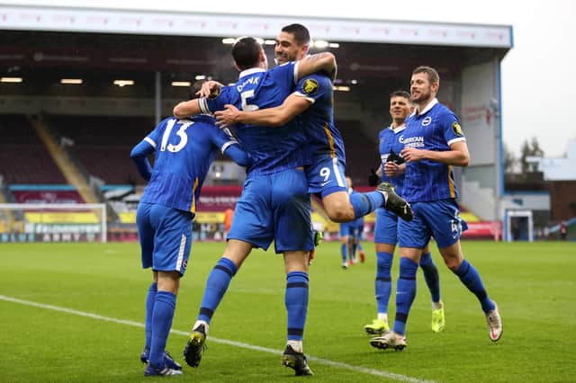 BURNLEY, ENGLAND - FEBRUARY 06: Lewis Dunk of Brighton and Hove Albion celebrates with teammates Pascal Gross and Neal Maupay after scoring his team's first goal during the Premier League match between Burnley and Brighton & Hove Albion at Turf Moor on February 06, 2021 in Burnley, England. Sporting stadiums around the UK remain under strict restrictions due to the Coronavirus Pandemic as Government social distancing laws prohibit fans inside venues resulting in games being played behind closed doors. (Photo by Clive Brunskill/Getty Images)