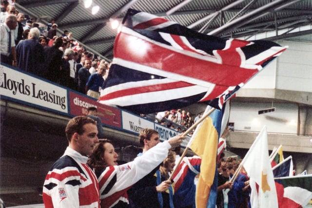 Swimmers parade with their national flags at the closing ceremony of the European Swimming Championships August 1993