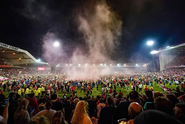 Nottingham Forest fans celebrate on the pitch after they reach the play off final during the Sky Bet Championship play-off semi-final, second leg match at the City Ground, against Sheffield United. Zac Goodwin/PA Wire.