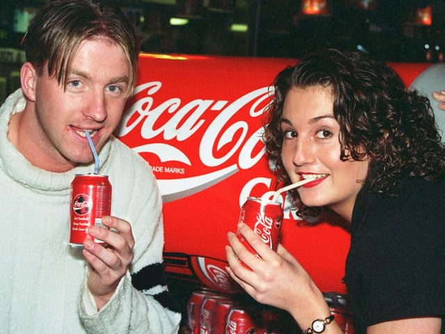 Kay Roberts, 23, collects her 365 cans of Coca-Cola courtesy of Karisma nightclub pictured with Doncaster Rovers player Colin Cramb in 1997