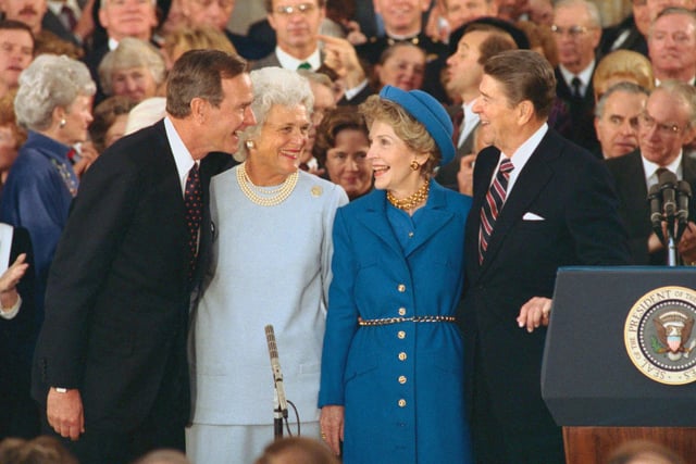 President and Nancy Reagan laugh with Vice President and Barbara Bush during inaugural ceremonies at the Capitol.