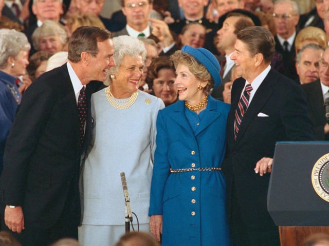 President and Nancy Reagan laugh with Vice President and Barbara Bush during inaugural ceremonies at the Capitol.