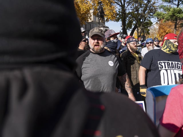 Trump supporters, rear, demonstrating the election results argue with counter protestors at the State Capitol in Lansing, Mich. (AP Photo/David Goldman)