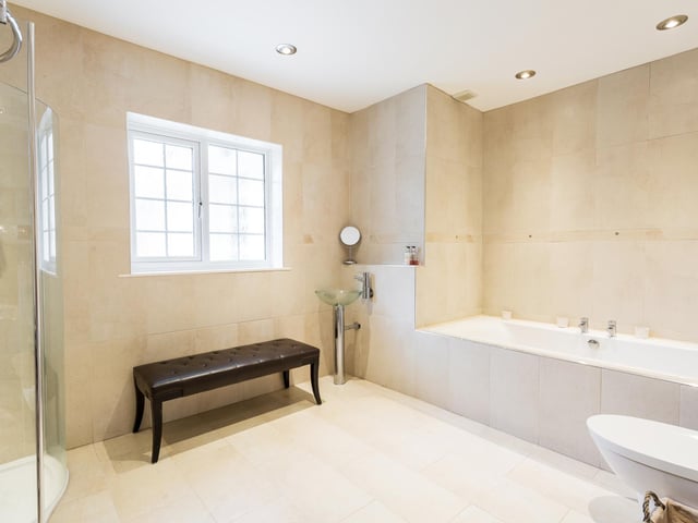 The huge family bathroom has a separate shower and bath.