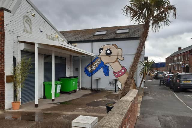 The lean-to has been scaled back to reveal Pete McKee's Frank the whippet artwork