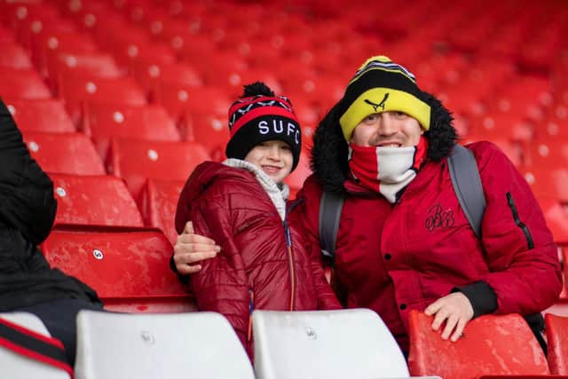 Sheffield United fan Nathan Ashforth, pictured with his young son at Bramall Lane, is hoping to let Chris Wilder's team know the supporters are still right behind them ahead of Sunday's game against West Ham