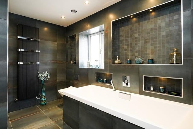 A stunning en-suite. The colours and finish are amazing, with a walk in shower just around the corner on the left of the image.