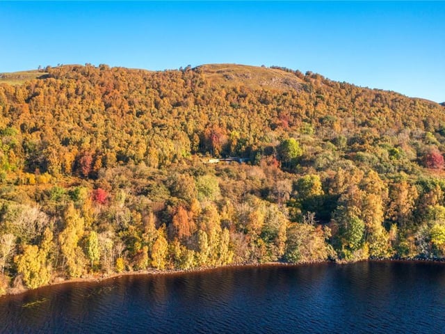 Aerial view showing secluded location of house.