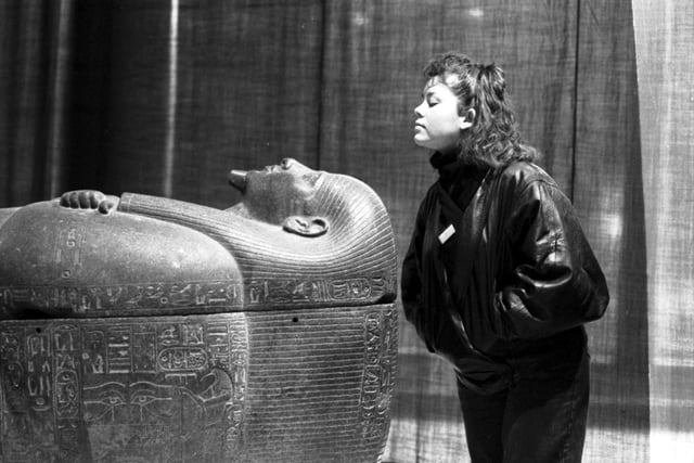 An unidentified female member of staff with the coffin of Psussenes , part of the Gold of the Pharaohs exhibition of ancient Egyptian artifacts at the City Art Gallery in Edinburgh, January 1988. This exhibition attracted an astonishing 447,000 visitors.