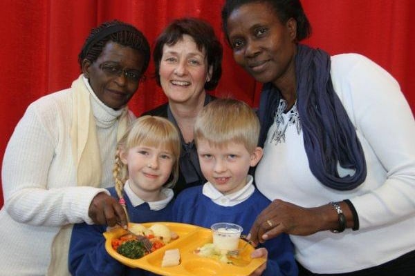 Hunloke Park School Overseas Visitors tried out school meals in 2010. L-R, Rose Izizinga, Julie Cadman (Headteacher), Margaret Rwabushaija with pupils Jasmin Smart (8), and Miles Oldale (8).