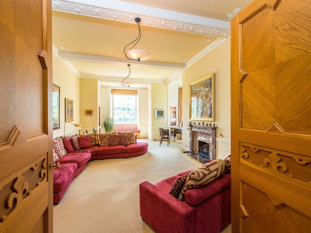The house has beautiful, carved doorways, leading to the bright, large rooms