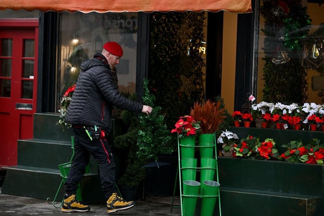A festive looking flower shop being dressed for filming.