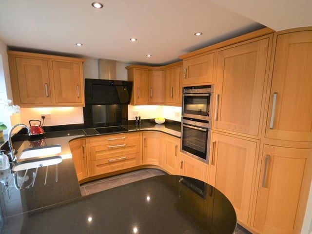 A superb dining kitchen with open plan access to the orangery. The kitchen boasts a stylish range of Oak wall and base units, complemented with stunning gloss black granite work surfaces, incorporating a one and a half bowl with chrome mixer tap. Neff integrated double ovens, Neff induction hob with matching extractor fan hood and splash back wall plate. Fridge freezer, dishwasher, inset down lighting and under cupboard lighting. A upvc double glazed window provides a pleasant outlook to the rear garden This beautiful kitchen is also complemented with contrasting floor tiles and under floor heating which continues throughout this large open plan living area.