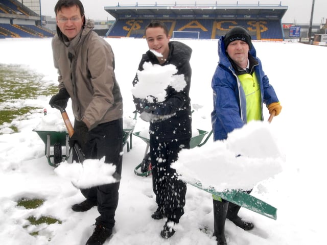 Stags fans Roger Stephenson, Daniel Worthington John Vardy  helped clear the snow at Field Mill  in 2010