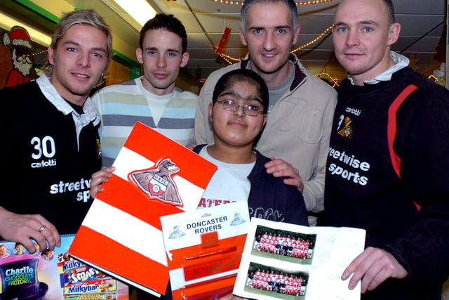 Dave Mulligan, Michael McIndoe, Andy Warrington and Tim Ryan are pictured with 11-year-old Qasim Sattar of Belle Vue during their DRI visit at Christmas 2005