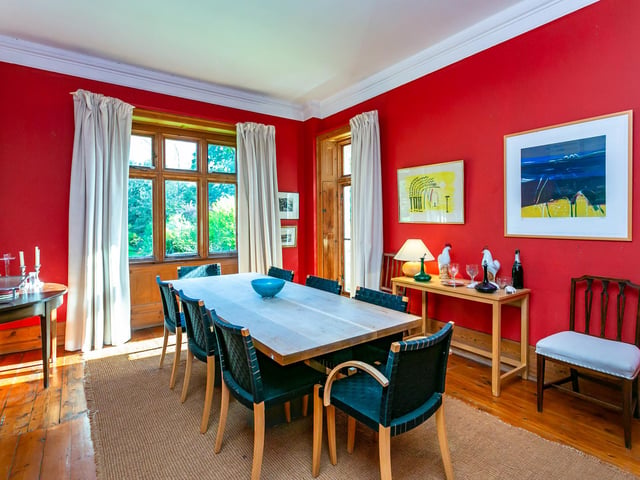 The formal dining room is both spacious and bright, with hardwood floors, large windows overlooking the gardens and enough room to entertain guests.