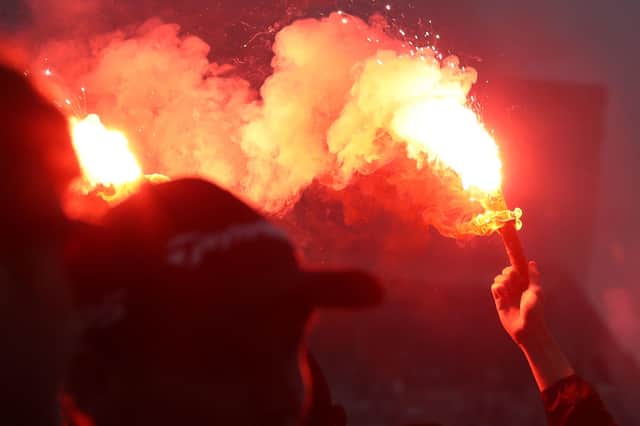 Liverpool fans let off flares outside the Liver Building in Liverpool. Peter Byrne/PA Wire