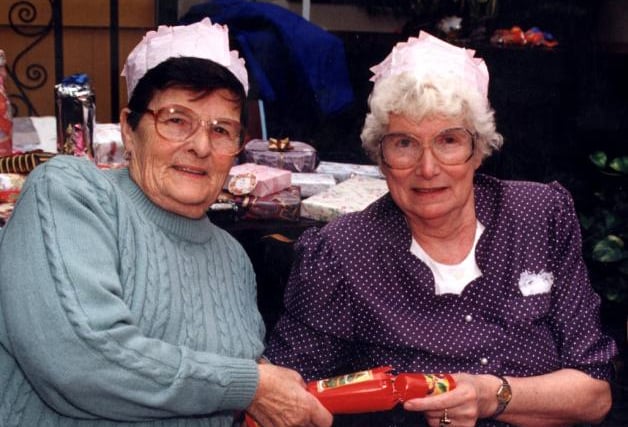 Eileen Walch and Mary Saul pulling a cracker in 1997.