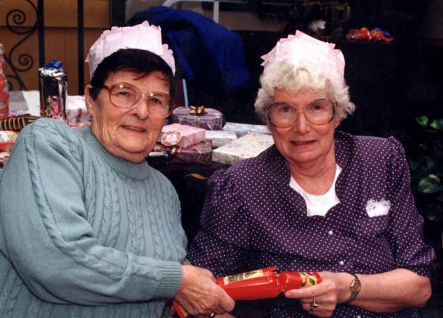 Eileen Walch and Mary Saul pulling a cracker in 1997.