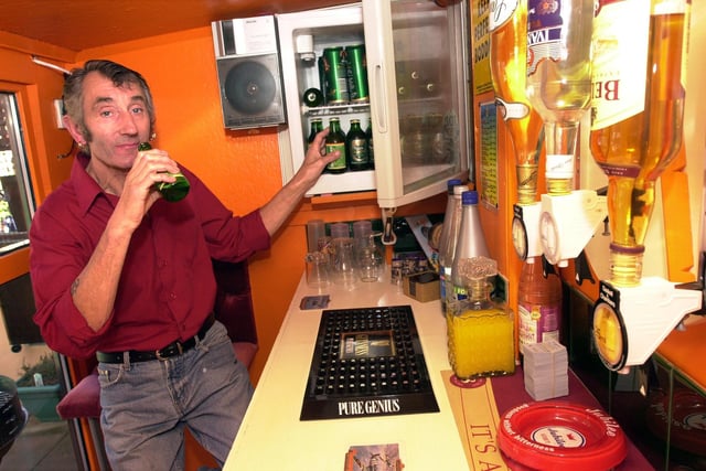 Hyde Park resident Lionel Overson downs a beer in his back garden bar in Childers Street in 2003
