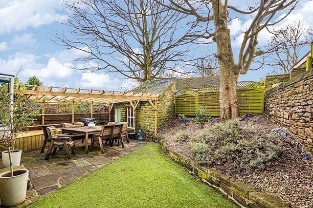 Outside there is a driveway for parking, and the garden is enclosed to incorporate a level lawned garden area in astroturf, as well as a patio with a gazebo and a stone-built store.