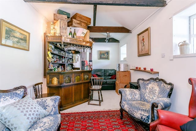 The stables have been converted into a veritable private pub with an oak corner bar - note the array of glasses ready for serving and the selection of snacks hanging on the left-hand side.
