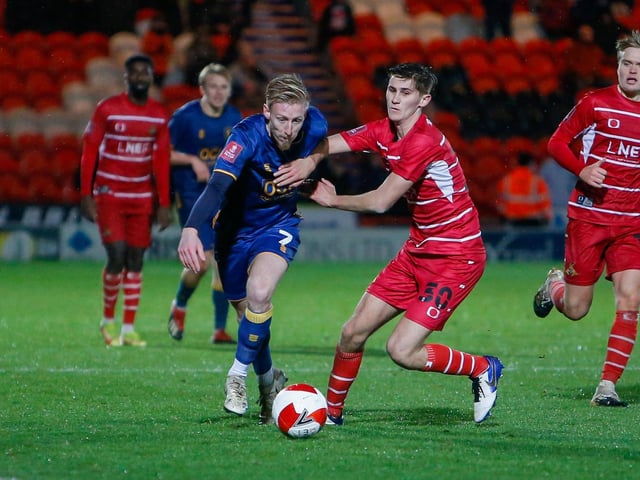 Mansfield Town midfielder Harry Charsley gets past his man.
