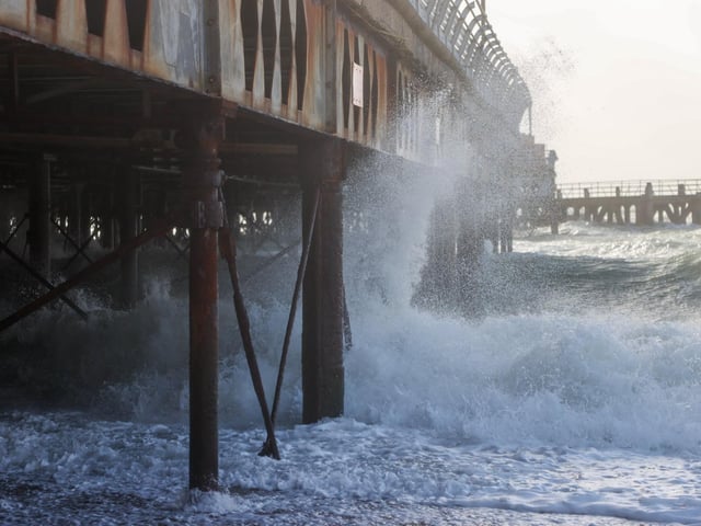 South Parade Pier saw large waves crashing against it. Photos by Alex Shute