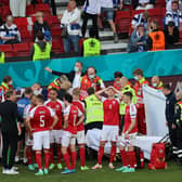 Christian Eriksen (hidden) receives medical treatment during the UEFA Euro 2020 Championship Group B match between Denmark and Finland on June 12, 2021 in Copenhagen, Denmark. (Photo by Wolfgang Rattay - Pool/Getty Images)