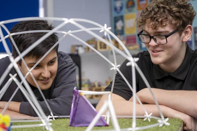 Ben Versi and Alfie Burgin work on a shelter  at a Design and Sustainability event at King Ecgbert School