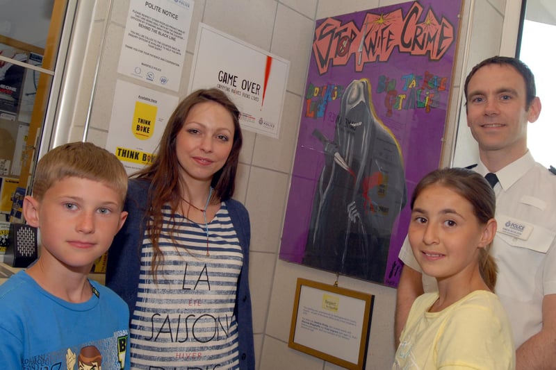 Winners of the Stop Knife Crime Poster competition Freddy Ingram, left, and Sharnnie Webster, second right, pictured with Chief Supt Simon Nickless and Bellamy Adventure Club's artist Jessica Greig.
