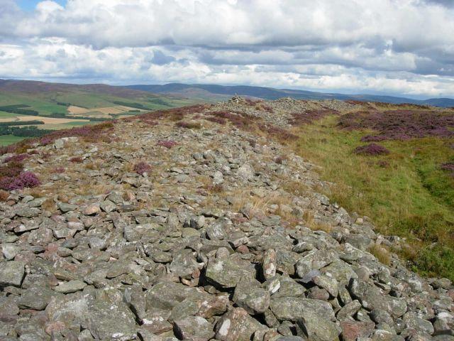 These Iron Age hill top settlements give tremendous sense of scale and space and afford an impressive panorama of the Highland line. Colours refer to the heather-covered turf and stone of one and the massive collapsed ramparts of the White. Sit here for a while and picture the Pict.