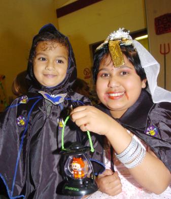 Ryan Jinaratana aged three and Sanjula Perara aged 10 from East Laith Gate at a Halloween party at the St James' Central Children's Centre. 2007.
