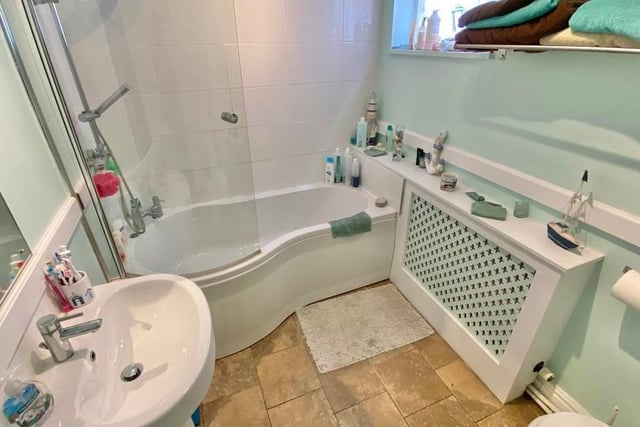 Another of the four bathrooms at The Gables Farm. This is fitted with a suite comprising bath with rain-head shower over, wash hand basin and low-flush WC, plus a radiator with a cover.