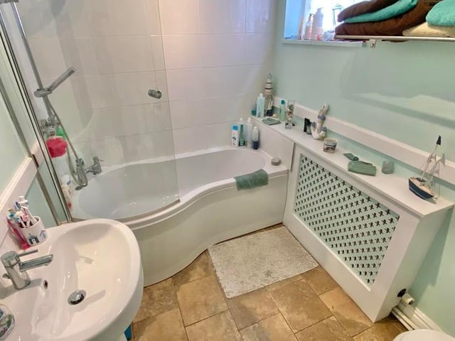 Another of the four bathrooms at The Gables Farm. This is fitted with a suite comprising bath with rain-head shower over, wash hand basin and low-flush WC, plus a radiator with a cover.