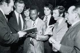 Pele signing autographs for Tony Pritchett, Jimmy Mullen, Allan Thompson, Tommy Craig and Eric Taylor alongside Derek Dooley