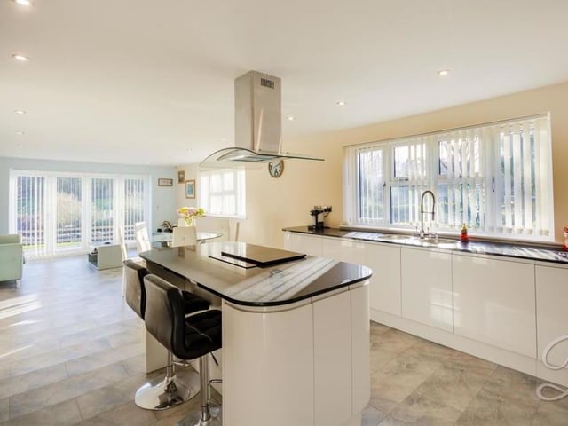 Catch the kitchen from another angle, and marvel at the room available. As well as two integrated ovens, there is a built-in dishwasher and space for a fridge freezer.