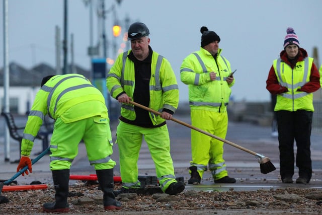 Colas contractors, working on behalf of the city council, clear up on Clarence Esplanade, Southsea, after Storm Barra. Picture: Chris Moorhouse   (jpns 071221-13)