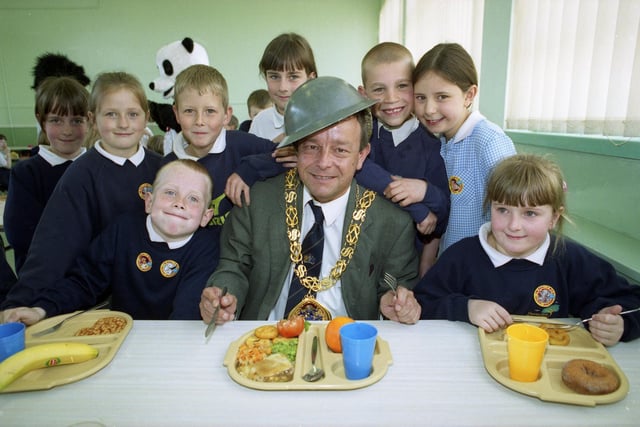 The Mayor Sunderland, Coun Wally Scott, dons a World War II steel helmet as part of lunchtime learning activities at Thorney Close Primary School in 1999