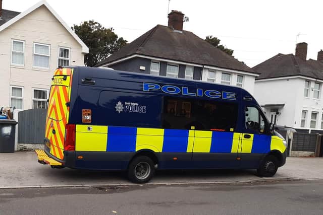 A large black police van was parked outside a house on Beck Street,  Shiregreen, with a marked police patrol car nearby. And across the street, a police dogs van was stopped, with its boot open.